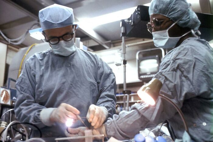 Two surgeons in scrubs and masks performing surgery in a sterile operating room during a bone-chilling surgery story.