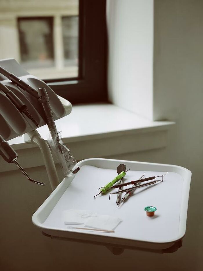 Dental tools and equipment set on a tray in a clinic, relating to bone-chilling stories of waking up during surgery.