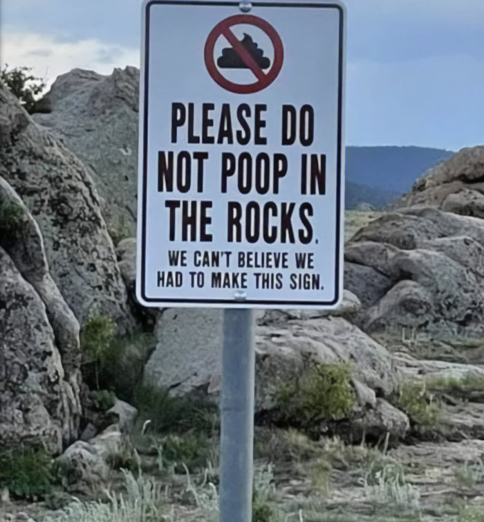 Funny and absurd sign outdoors warning people not to p**p in the rocks, shared for hilarious signs on Facebook group.