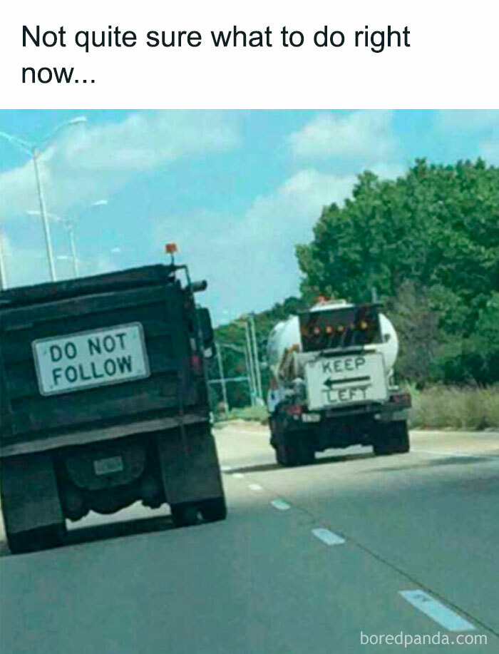 Two trucks on a highway with conflicting signs creating a hilarious and absurd sign spotted and shared online.