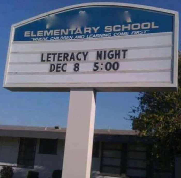 Elementary school sign with a humorous spelling error promoting literacy night at 5 PM on December 8, a hilarious absurd sign example.