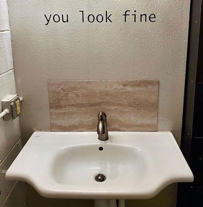 Bathroom sink with faucet under a wall sign saying you look fine, a hilarious and absurd sign spotted by people.