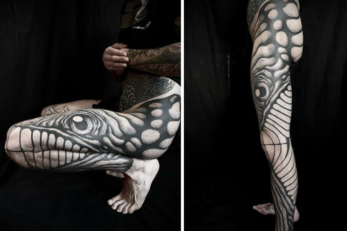 Tattoo reveals a snake or fish design on a leg, its form changing as the leg moves.