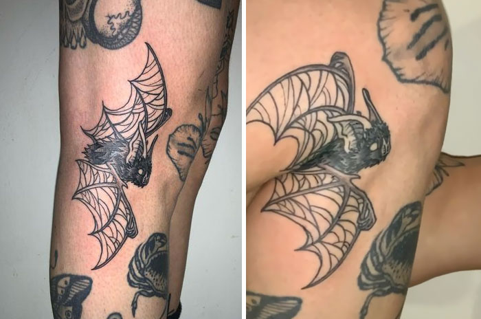 Tattoo of a bat on an arm reveals details when muscles move, showcasing genius tattoos in motion.