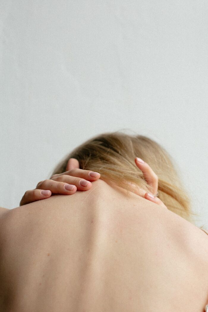 Close-up of a person’s bare back and hands, highlighting disturbing things about human bodies and skin details.