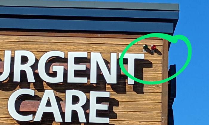 These Red And Green Lights On The Outside Of This Medical Clinic