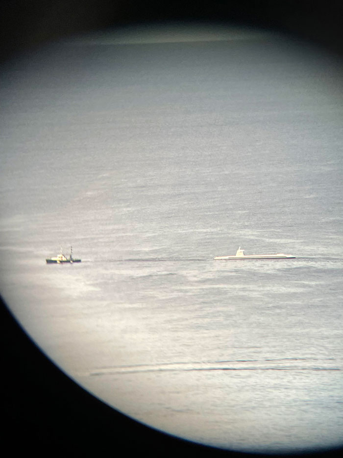 White Submarine-Shaped Boat Getting Towed Every Morning And Afternoon Along The Shoreline Of Honolulu, Hawaii