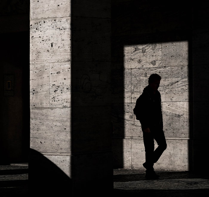 Man walking and shadows in a sunny day 