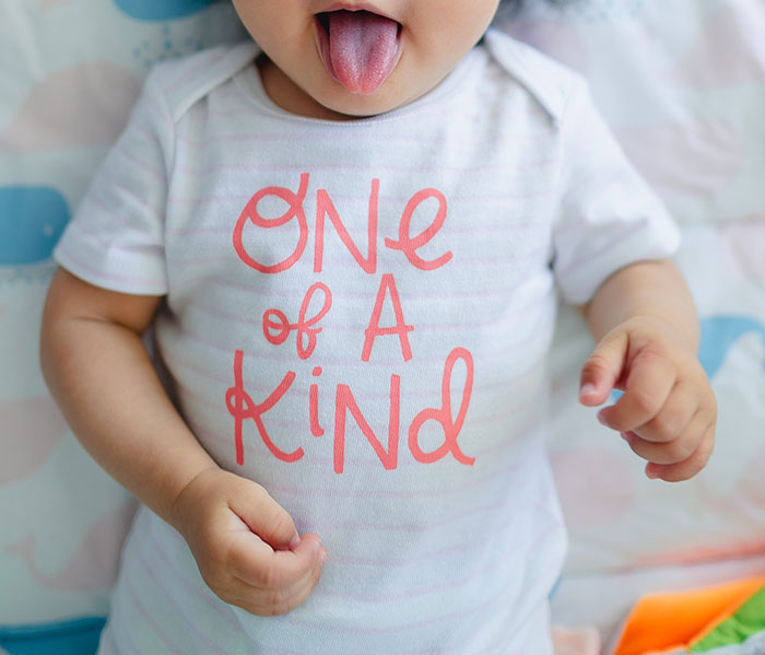 Lying baby with his tongue out 