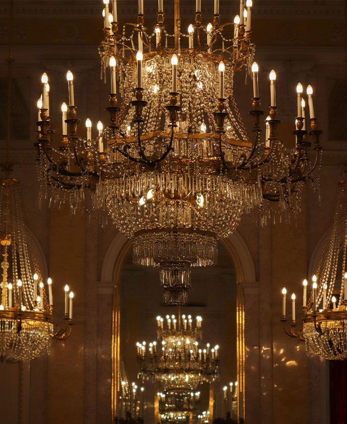 Massive lit up chandelier in a big room 