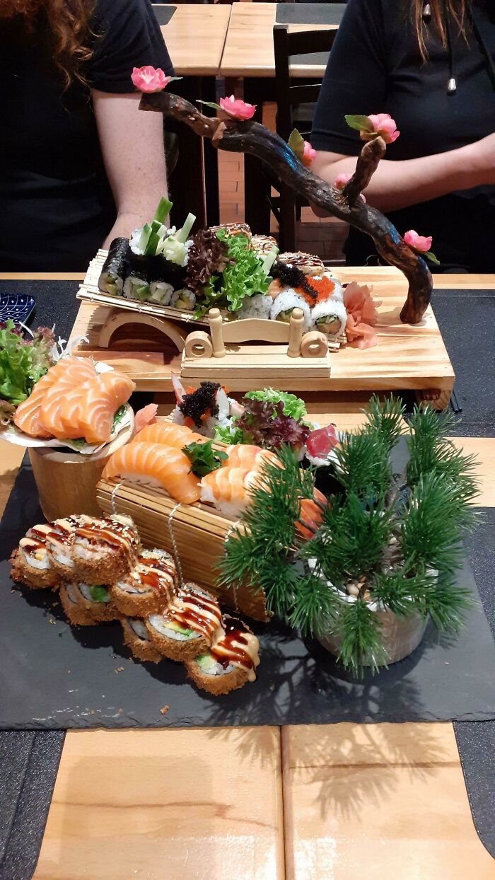 This Sushi Came On A Slate And Included Salad In A Seashell And Sushi Rolls On A Tilted Ramp