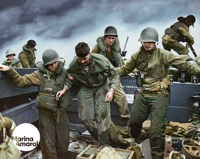 A Marine Is Transferred By Coast Guardsmen To A Landing Boat Off The Flaming Shore Of Iwo Jima, Wwii.