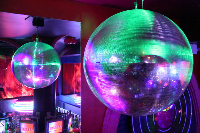 Disco ball reflecting colorful lights in a room, illustrating unique and startling windshield notes found by folks.