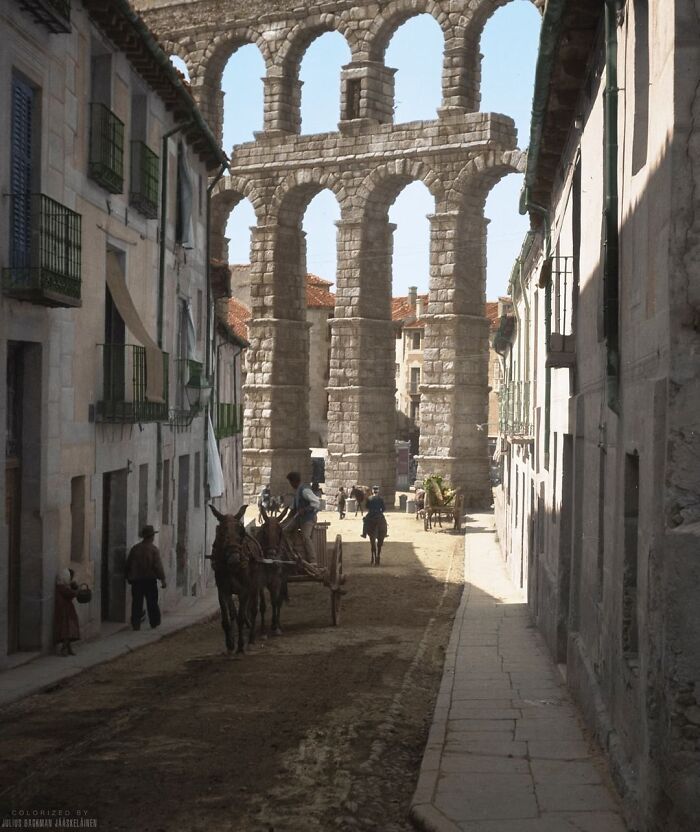 A Street In The City Of Segovia In Spain Photographed In C. 1904. In The Background, You Can See The Famous Roman Aqueduct Of Segovia Which Is Believed To Have Been Constructed Between The 1st And 2nd Century Ad. This Photo Was Taken By German-American Photographer Arnold Genthe During His Travels Around Europe At The Beginning Of The 20th Century