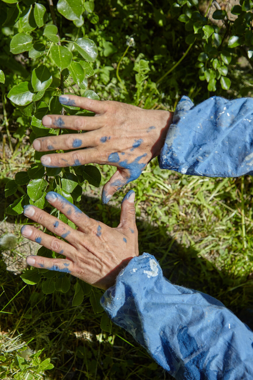 The Painter-Climber Paints The Chimney. A Worker On A Blue Sky Background.