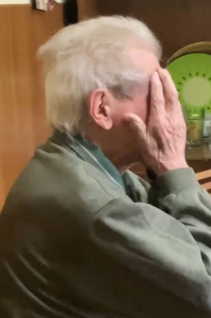 Elderly person covering face, reacting emotionally to girl's tattoo.