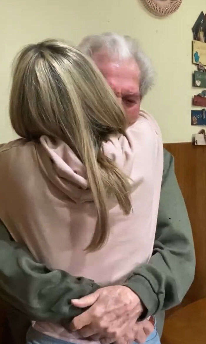 Grandparents' emotional reaction to a girl's tattoo captured in a heartfelt hug, widely shared on social media.