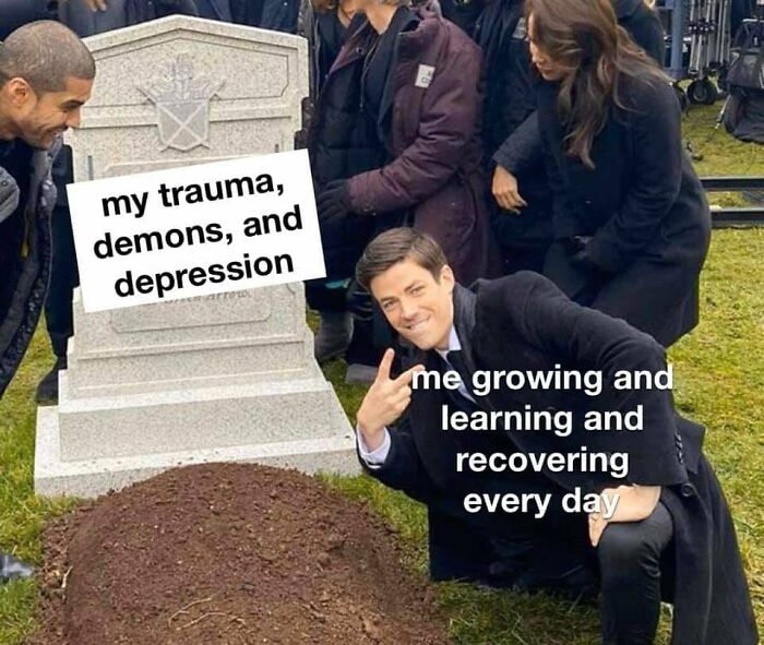 Man posing by a grave labeled with trauma, symbolizing recovery and wholesome growth.