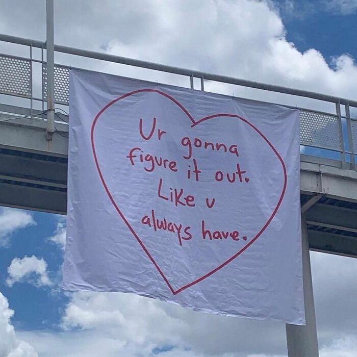 Heart-shaped banner with encouraging message, reminding us that the world isn’t all bad.