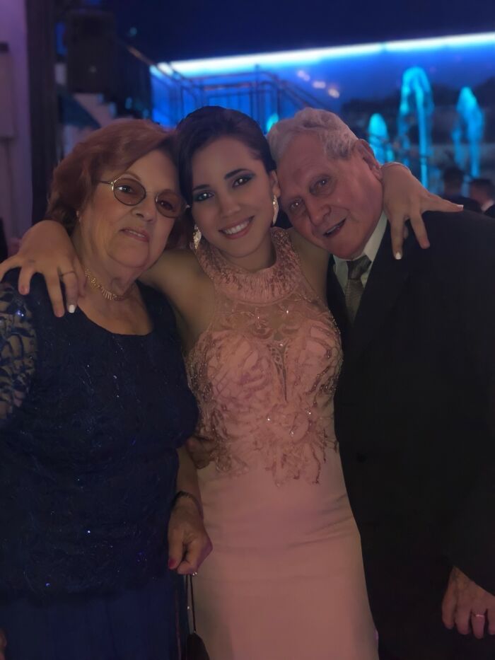 Young woman with her grandparents, capturing an emotional moment, touching many on social media.