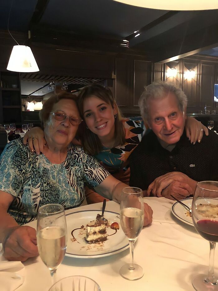 Girl showing tattoo to grandparents at dinner, evoking touching reactions shared by social media users.