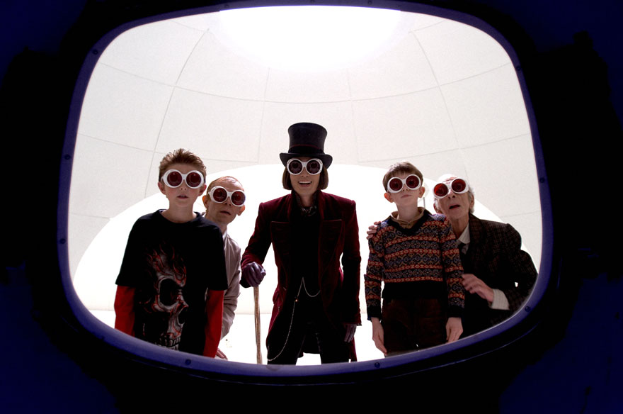 W***y Wonka and four other characters wear funky sunglasses and are in a chocolate factory