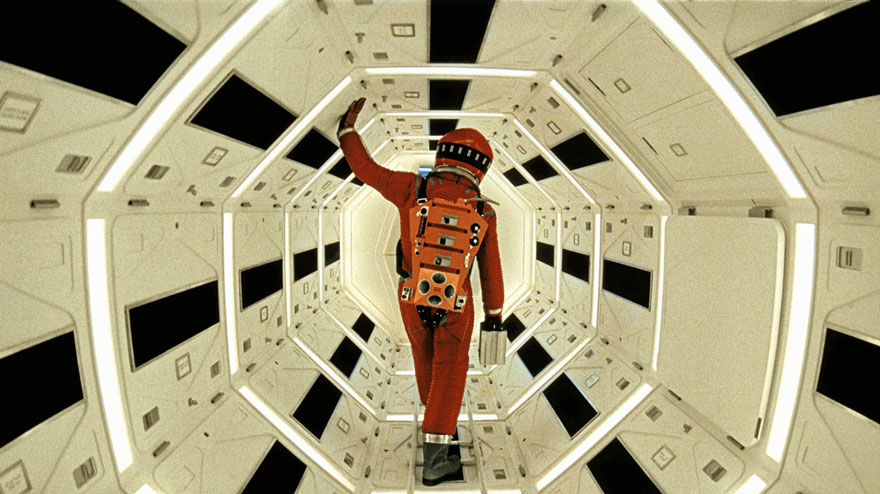 A man in a red astronaut costume walks in a space shuttle