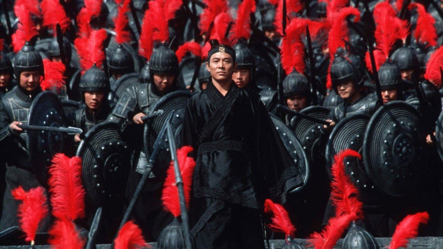 Asian man in black clothes standing and the armored army stands behind him