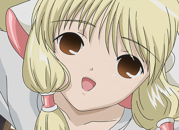 Blonde female anime character with large eyes, pink hair accessories, and a cheerful expression.