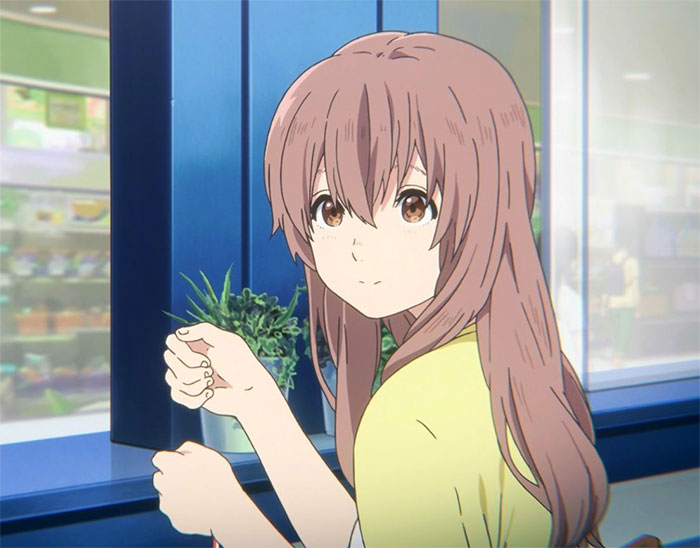 Anime girl with long brown hair sitting by a window, wearing a yellow top, looking back with a gentle expression.