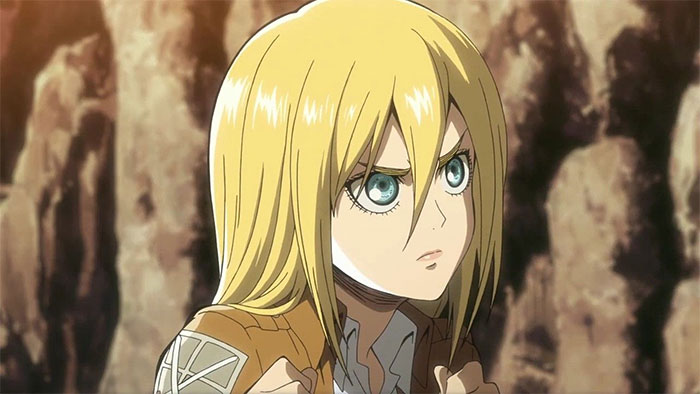 Blonde female anime character with determined expression, wearing a military-style jacket, popular among fans.