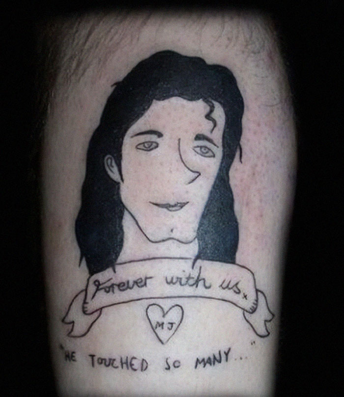 Poorly drawn tattoo of a person's face with "Forever with us" banner and initials "MJ."