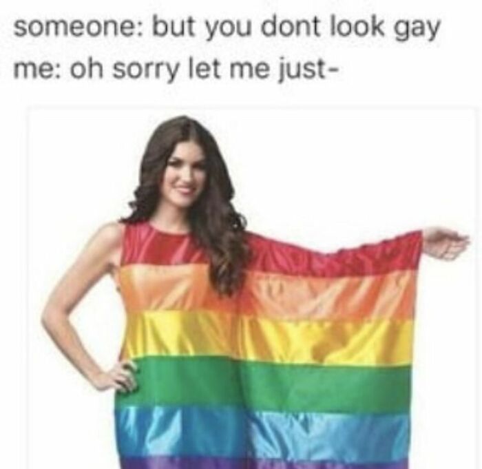 Woman humorously wearing a rainbow flag dress in response to a comment, highlighting LGBTQ+ identity.