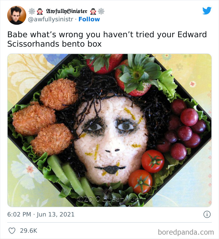 Bento box food art resembling Edward Scissorhands face surrounded by vegetables and fruits, example of food with threatening auras.