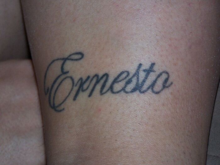 Tattoo of the name "Ernesto" in script font on skin, considered a major red flag by some people.