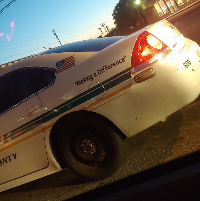 The Cop Cars In Orange Country Florida All Say Making A Difference In Comic Sans With Useless Quotation Marks. Makes It Seem Like They Aren't Making A Difference