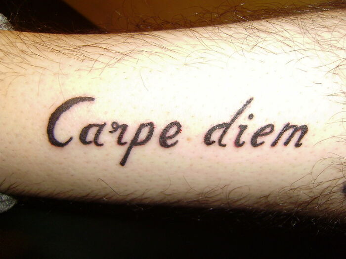 Tattoo reading "Carpe Diem" on a forearm, considered a major red flag by some people.