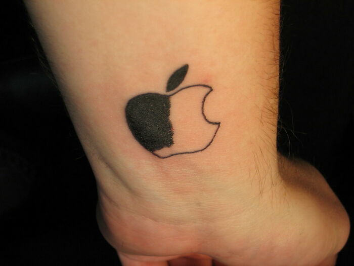 Tattoo of an Apple logo with an incomplete fill on a wrist, considered a major red flag by some people.