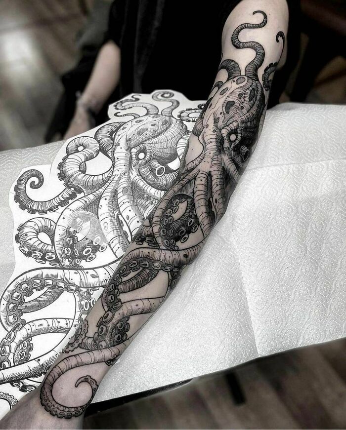 Arm inked with a detailed octopus tattoo design, showcasing intricate tentacle patterns.