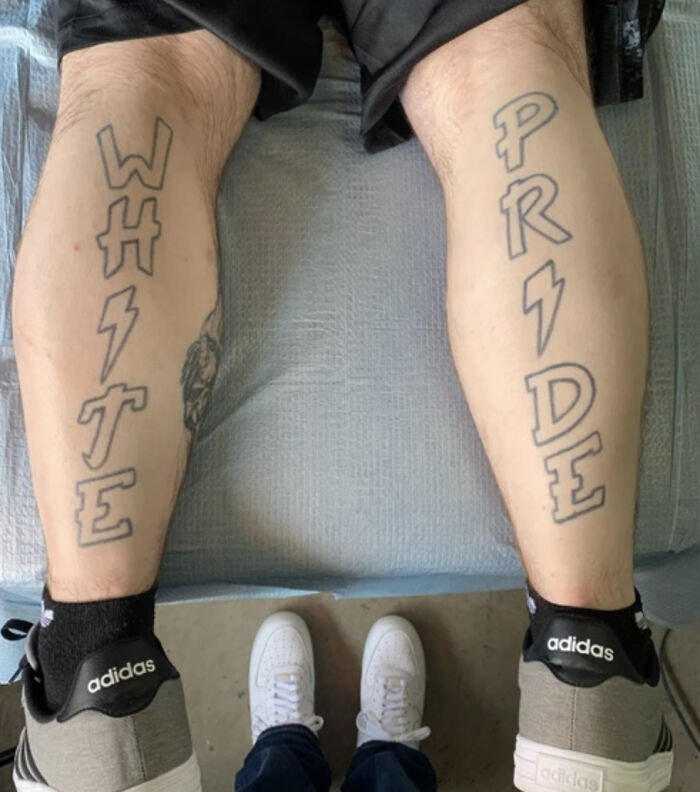 Controversial tattoos seen on calves, wearing Adidas shoes.