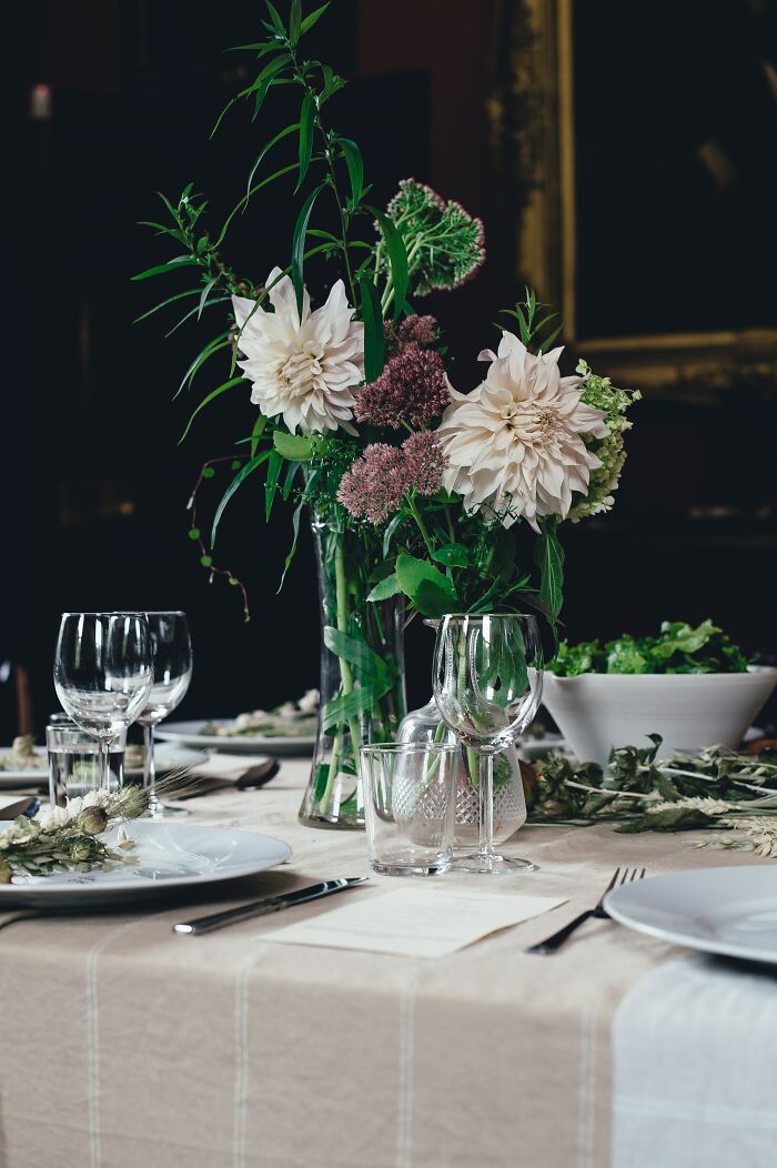 Wedding table setting with flowers, glassware, and plates, illustrating weird wedding experiences and celebrations.
