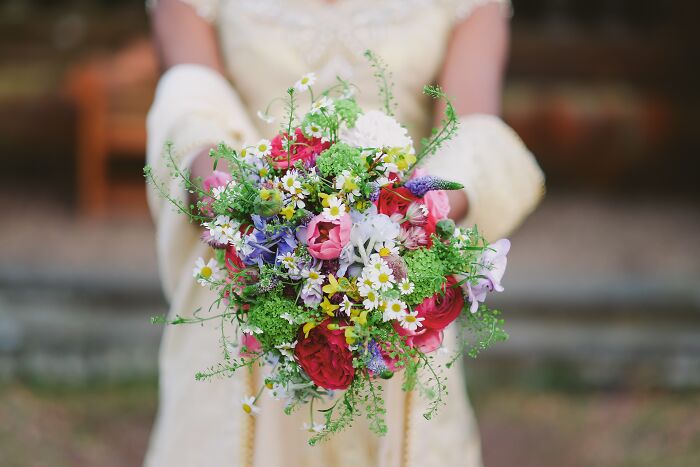 Close-up of a colorful wedding bouquet held by a bride, illustrating one of the weirdest wedding experiences.