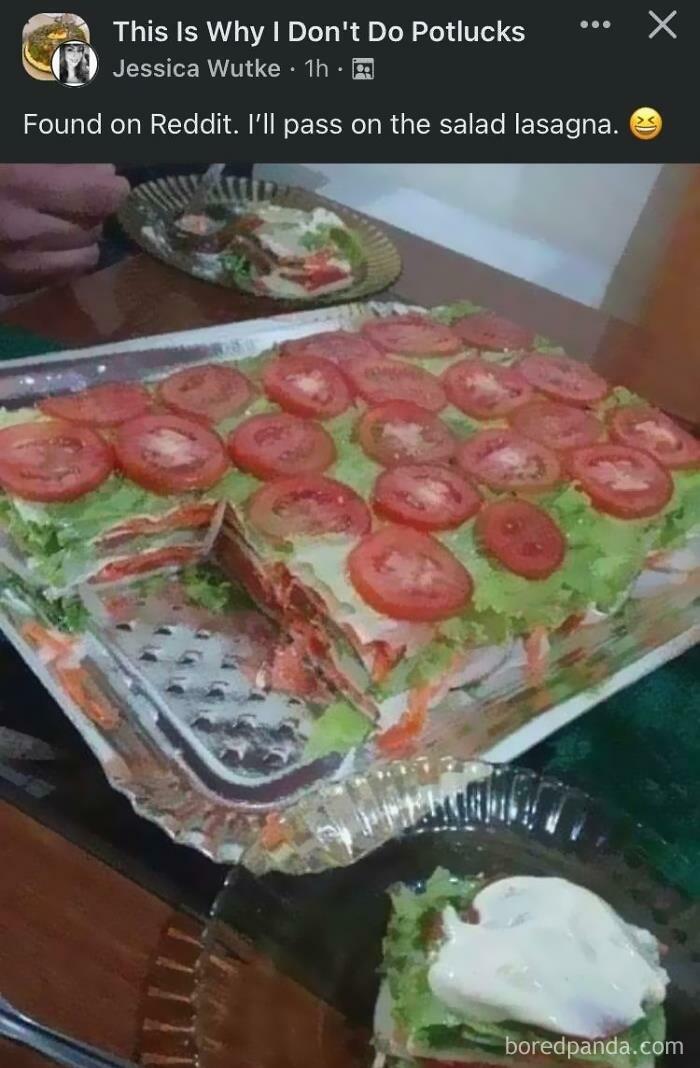 Salad lasagna with layers of lettuce, tomatoes, and dressing served on a glass tray, example of food with threatening auras.