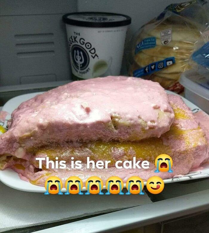 Unappetizing pink frosted cake in fridge with melting texture, an example of food with threatening auras shared online.