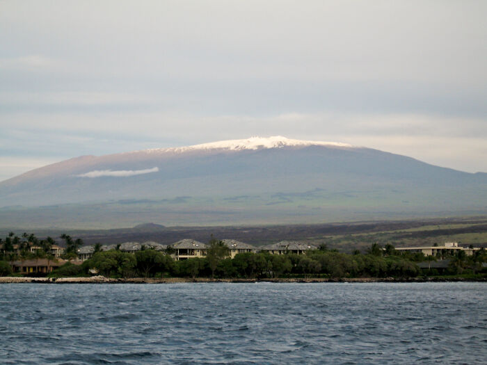 Ocean view with distant mountains and cloudy sky, illustrating one of the creepiest facts about the ocean environment. - 16