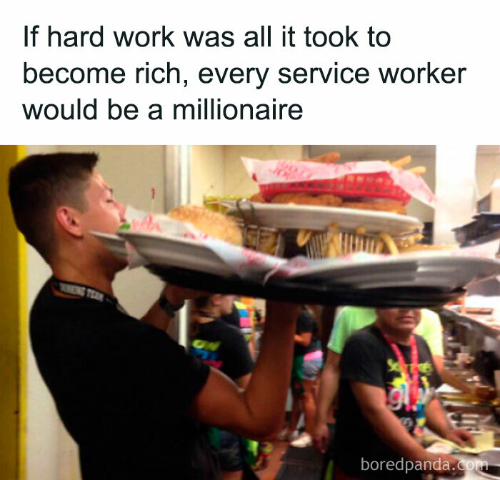 Man balancing multiple plates of food in a busy restaurant with anti-work humor about hard work and wealth.