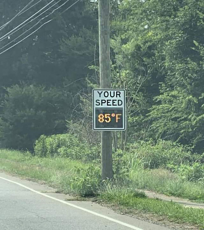 Speed sign displaying temperature instead of speed on roadside, example of bad drivers shared in popular Facebook group.