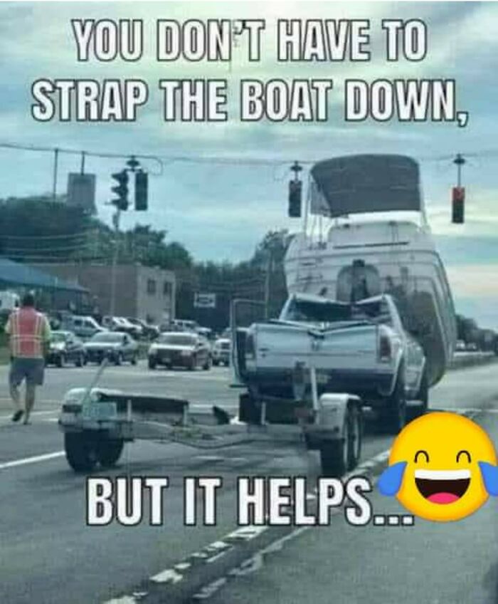 Pickup truck carrying a boat improperly secured on a busy road, illustrating examples of bad drivers and their mistakes.