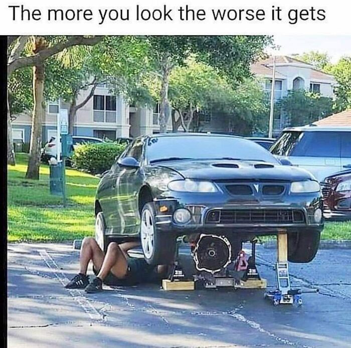A person working under a car improperly supported, showcasing bad drivers in a Facebook group with funny posts.