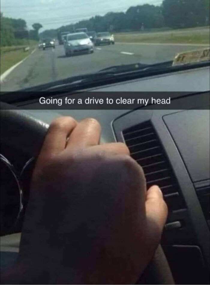 Driver holding steering wheel incorrectly while on a highway, illustrating examples of bad drivers shared in a Facebook group.